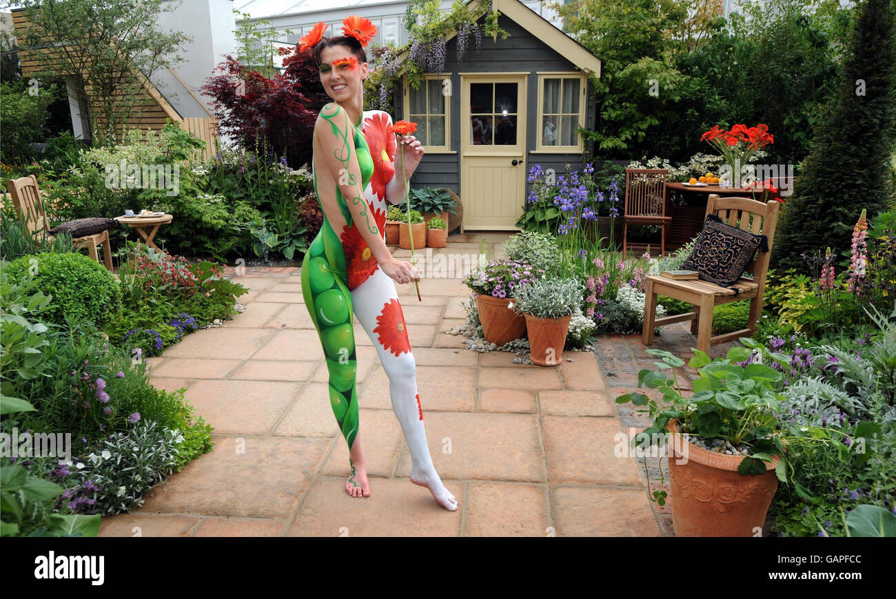 Model Suzi Taylor's body is painted symbolising the twin themes of sustainability and adaptability in the Real life by Brett Garden at the Chelsea Flower Show, London. Stock Photo