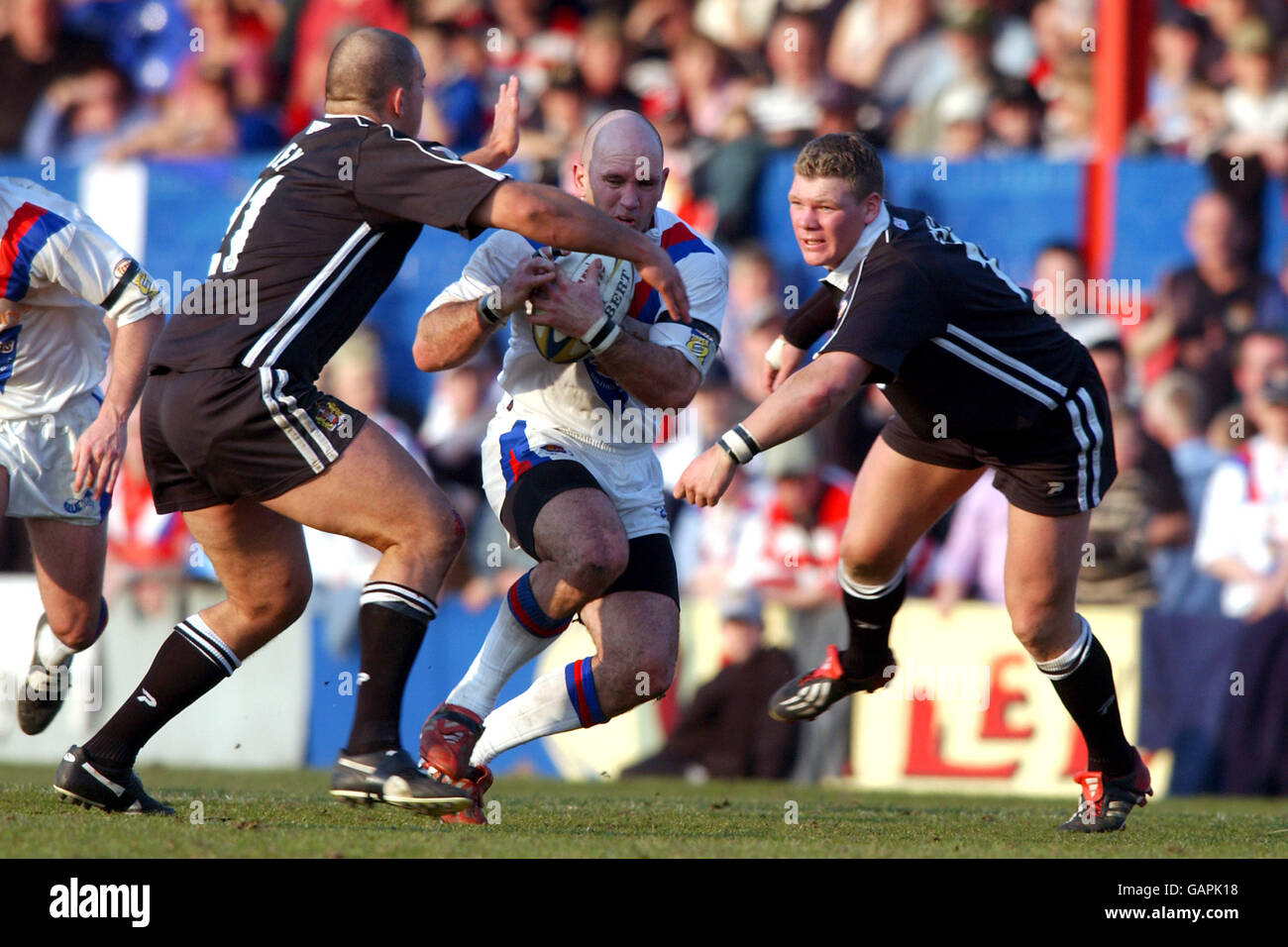 Wakefield Trinity Wildcats' Adrian Vowles takes on Wigan Warriors' Ricky Bibey (l) and Danny Tickle (r) Stock Photo