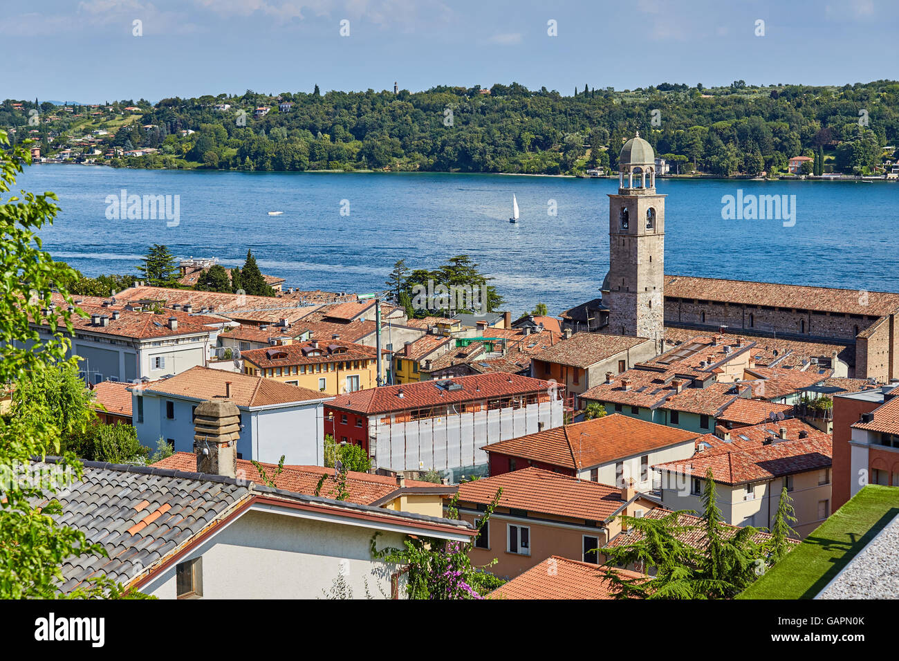 Roof with red tile houses and scenery on Lake Garda in Italy, with yacht Stock Photo