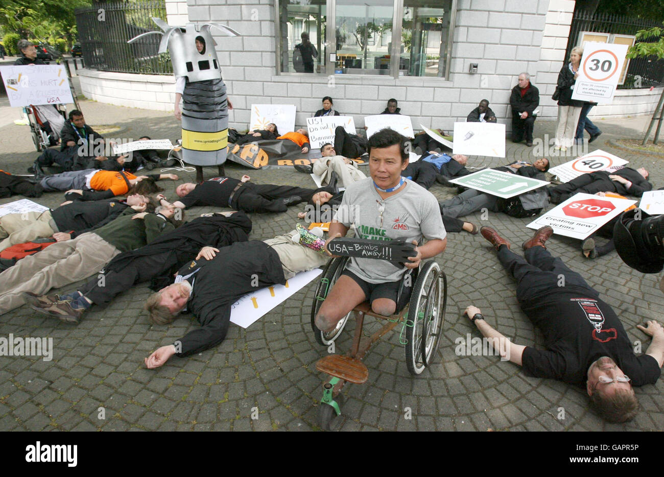 Landmine victim Tun Channareth, from Cambodia, (centre) takes part in a protest by the Cluster Munition Coalition outside the US Embassy in Dublin. Stock Photo