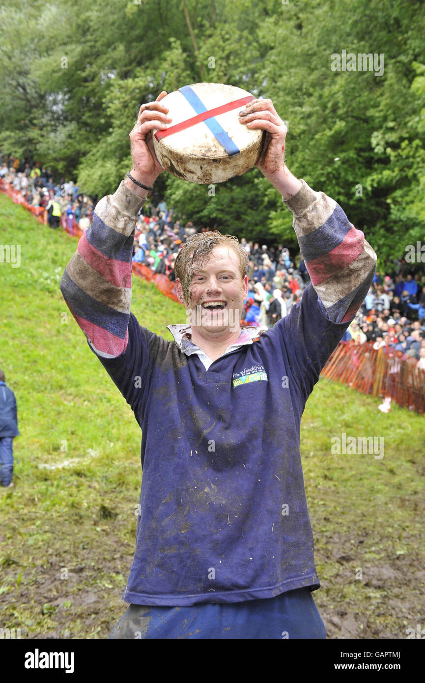 Winner of the second race at the annual cheese rolling event at Coopers Hill, Gloucestershire, Peter Mackenzie-Shaw, 33, from Hereford. Stock Photo