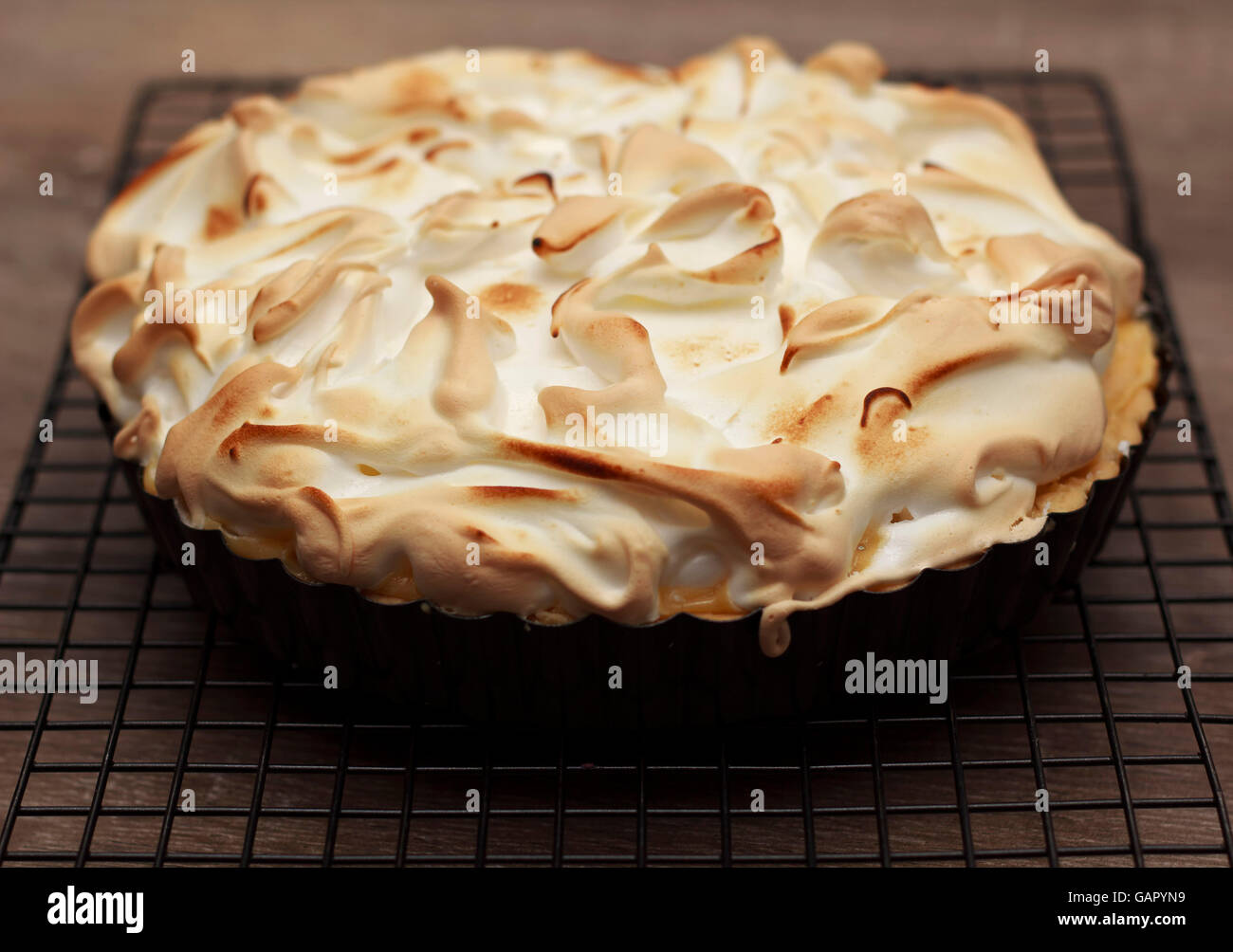 Lemon meringue pie on a cooling rack Stock Photo
