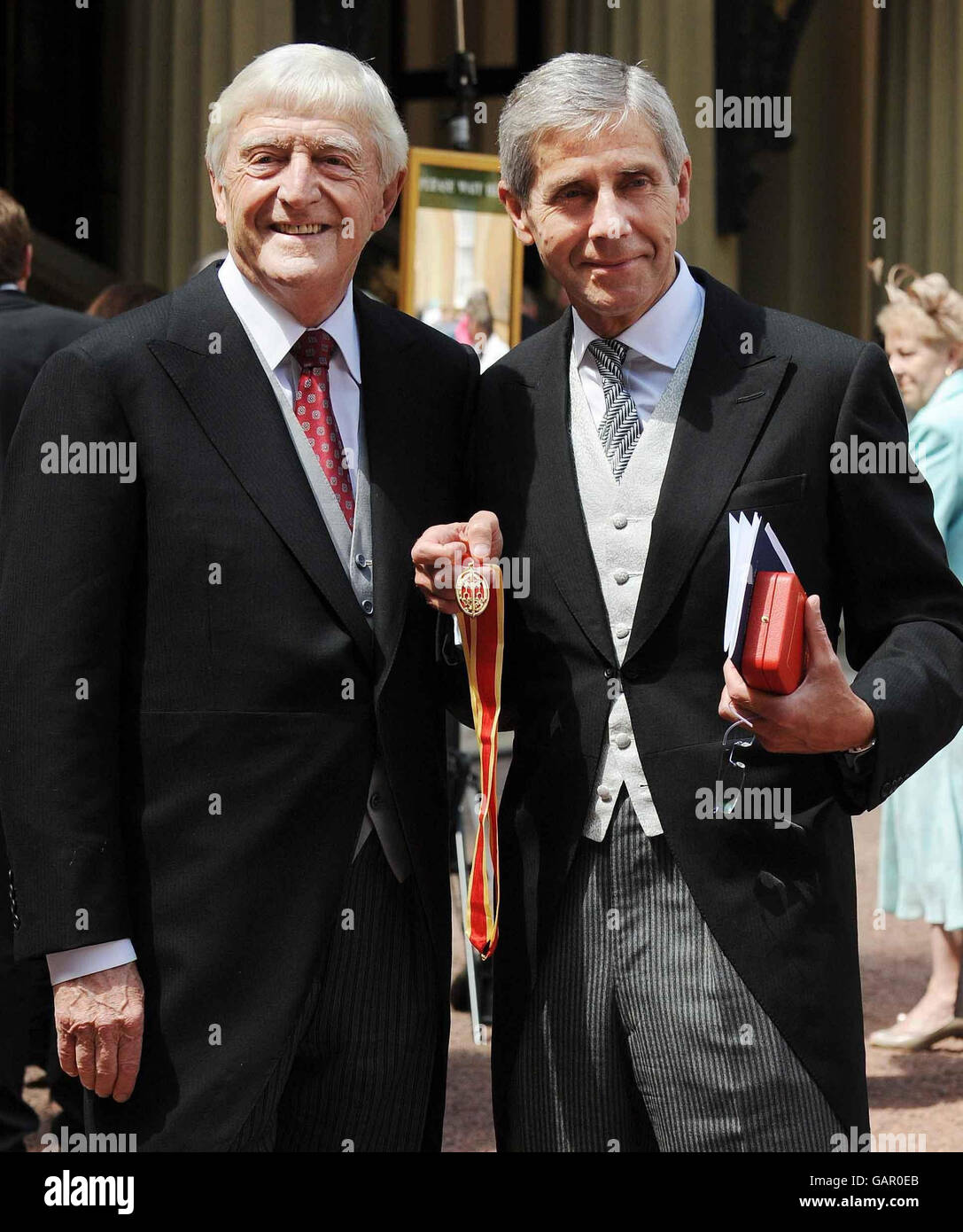 Sir Michael Parkinson (left) and Sir Stuart Rose, CEO of Marks and Spencer, after they collected their Knighthoods from Britain's Queen Elizabeth II at Buckingham Palace, London. Stock Photo