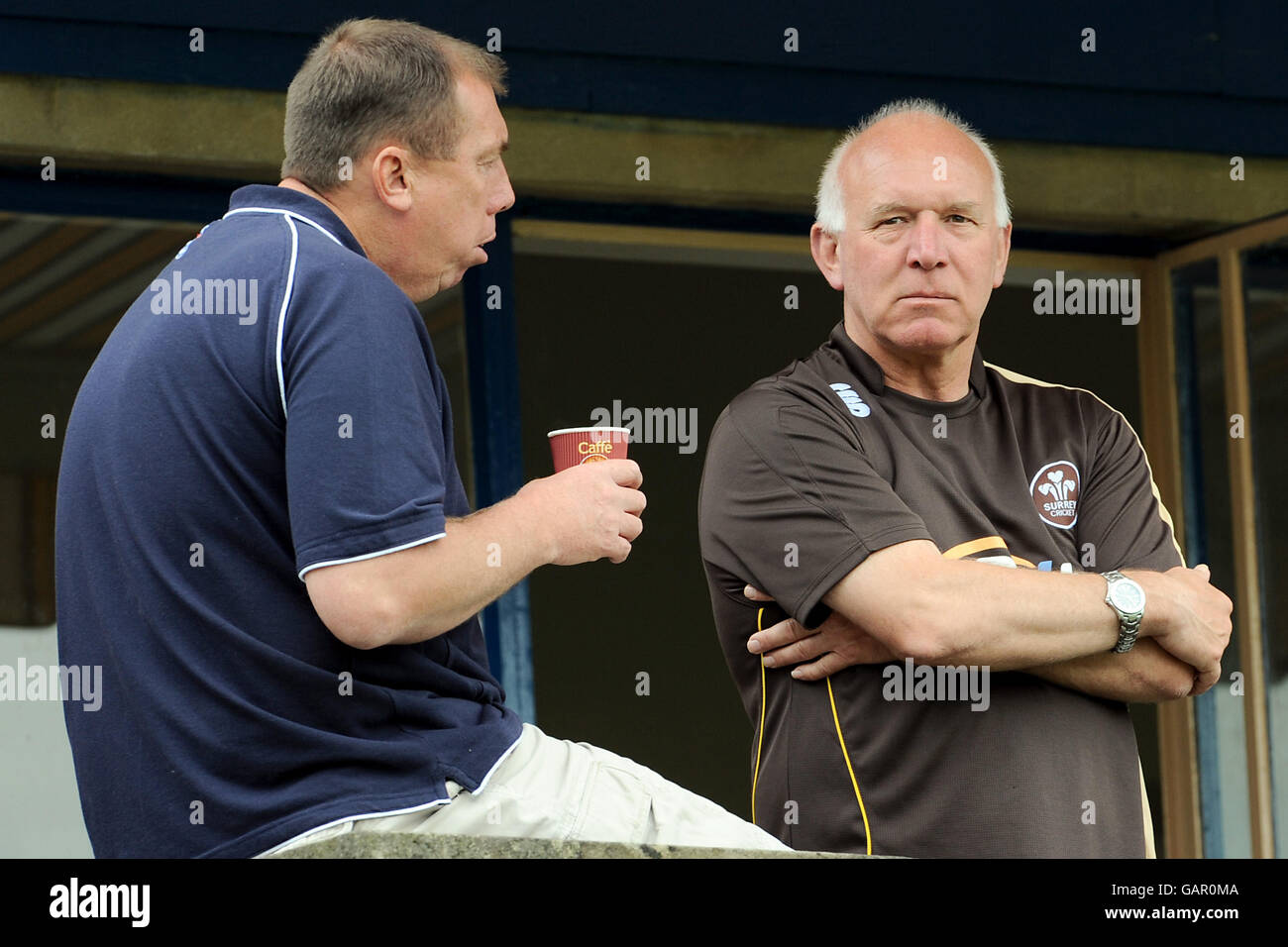 Surrey's coach Alan Butcher (r) chats with former Surrey player and now teacher at Whitgift School David Ward on the balcony of the pavilion at the Whitgift School Stock Photo