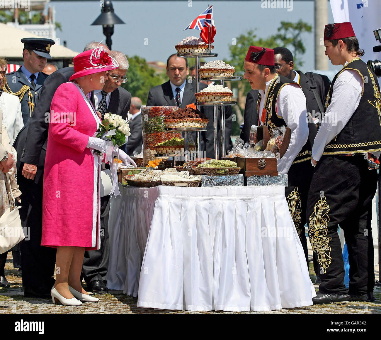 Britain's Queen Elizabeth II examines local food during a visit to Kabatas high school in Istanbul. It is the third day of the Queen's state visit to the Republic of Turkey. Stock Photo