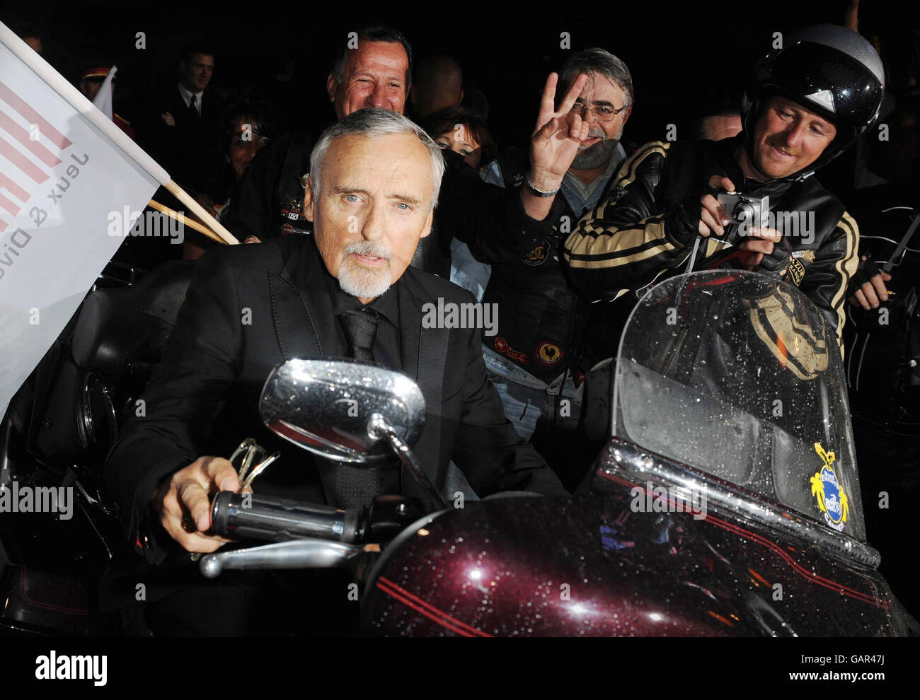 AP OUT Actor Dennis Hopper mounts a Harley Davidson as he arrives at the Palm Beach Casino for the Partouche Charity Poker Festival in Cannes, France during the 61st Cannes International Film Festival. Stock Photo