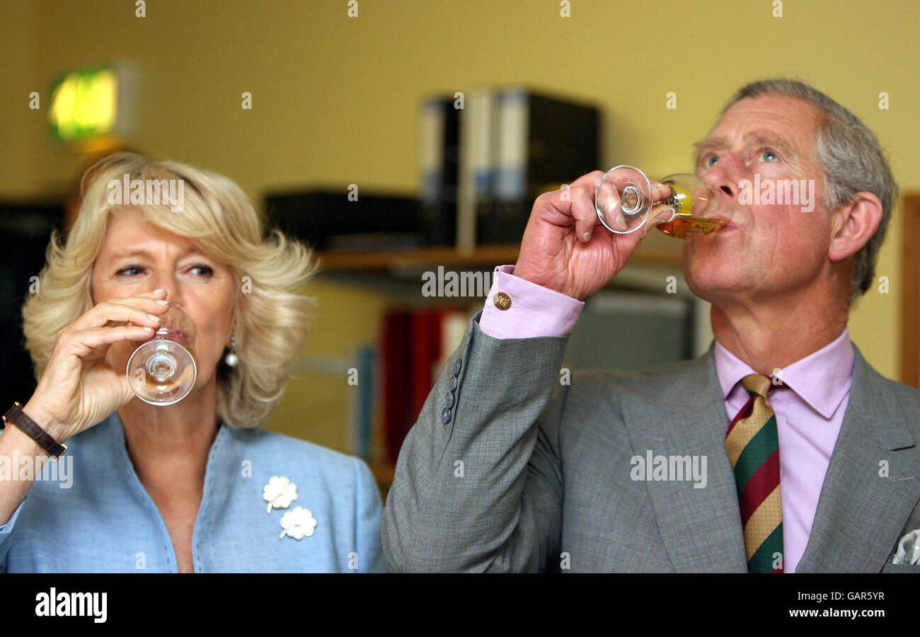 The Prince of Wales and the Duchess of Cornwall try some Bushmills whiskey on a visit to the Distillery in Co Antrim, Northern Ireland. Stock Photo