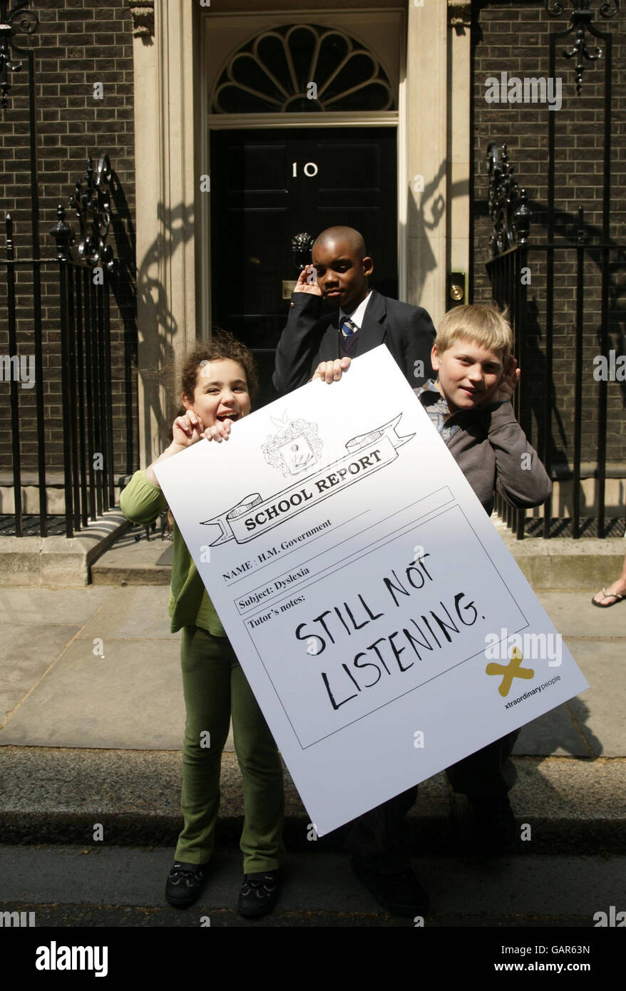 Southwark schoolchildren with dyslexia (L-R) Cara Abraham, Lenny Zvinoria and Cameron Simson outside 10 Downing Street, central London, before delivering an 'end of school term report' urging the government urging them to fast-track their support for dyslexic children and their families following a series of damning reports from dyslexia charity Xtraordinary People. Stock Photo