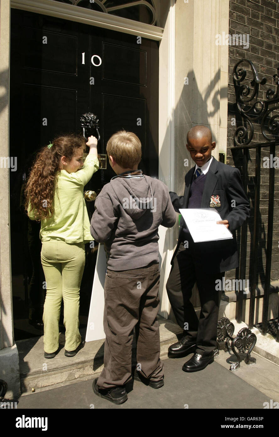 Southwark school children with dyslexia (L-R) Cara Abraham, Cameron Simson and Lenny Zvinoria outside 10 Downing Street, central London, to deliver an 'end of school term report' urging the government to fast-track their support for dyslexic children and their families following a series of damning reports from dyslexia charity Xtraordinary People. Stock Photo