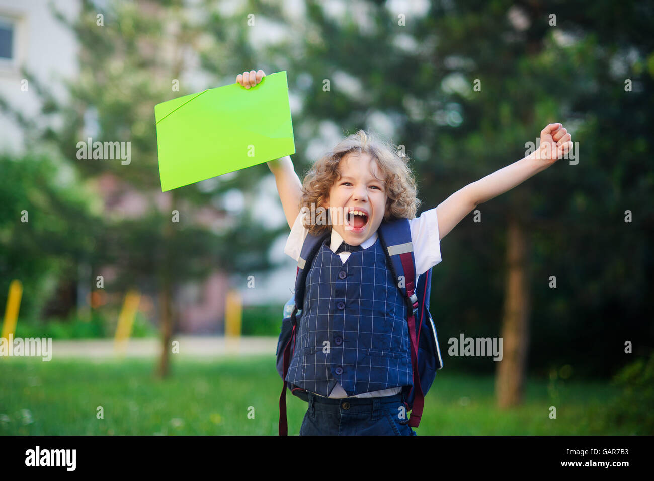 Little learner angry. The boy lifted up both hands and clenched his