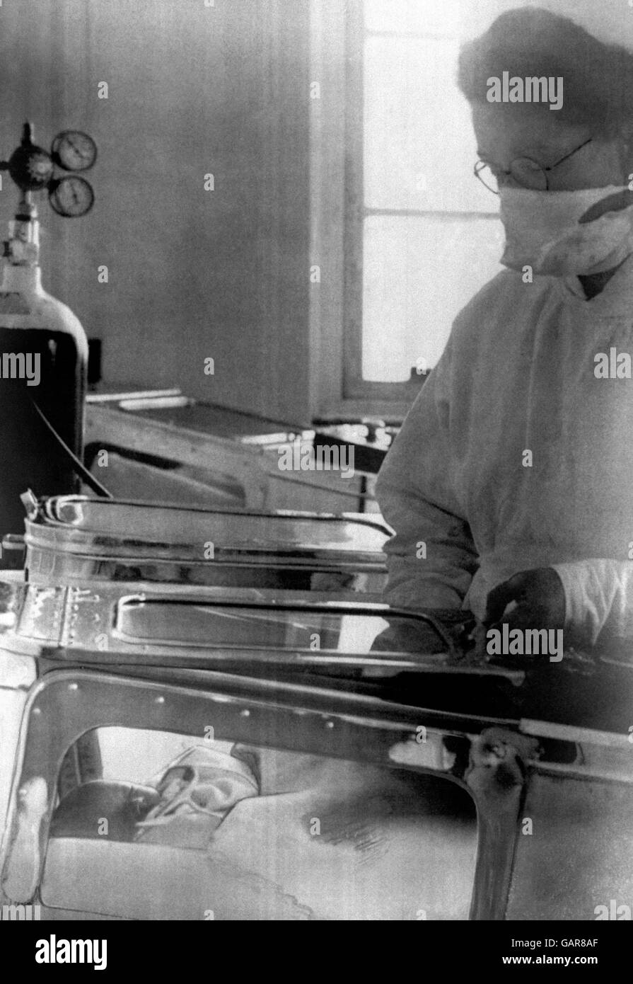 The quadruplets, all girls, born to Mrs Margaret Elizabeth Good, wife of a Gloucestershire farmer, are reported to be doing nicely. Sister Margaret Bright is seen keeping a watchful eye on one of babies lying in an oxygen cot in Southmead Hospital, Bristol. Stock Photo