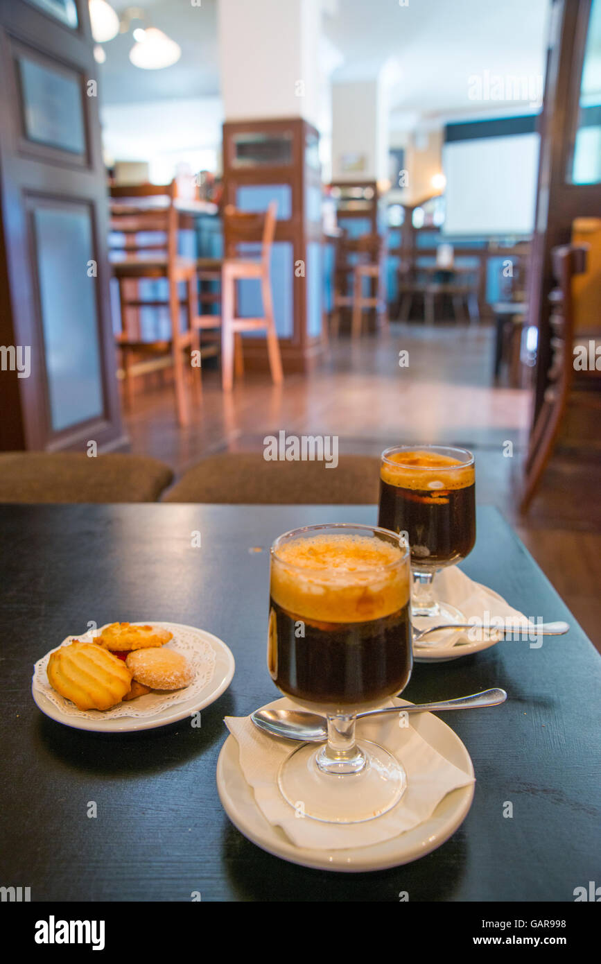 Two carajillo coffees with biscuits in a cafe. Madrid, Spain. Stock Photo