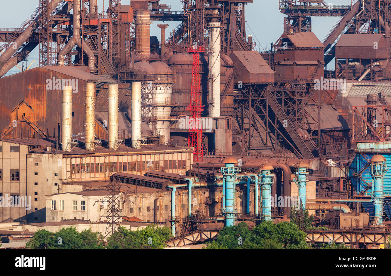 Rusty steel factory with smokestacks at sunset. metallurgical plant. steelworks, iron works. Heavy industry in Europe. Air pollu Stock Photo