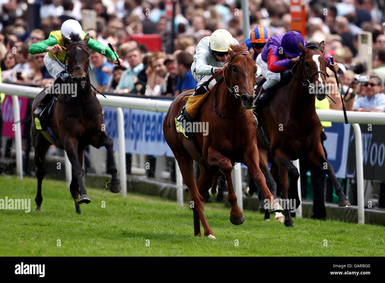 Conduit riden by Ryan Moore leads the field to win the totesportcasino.com Stake at Epsom Downs Racecourse, Surrey. Stock Photo