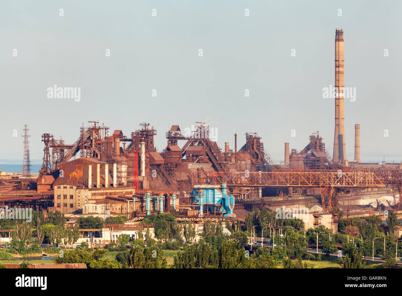 Steel factory with smokestacks at sunset. metallurgical plant. steelworks, iron works. Heavy industry in Europe. Air pollution f Stock Photo