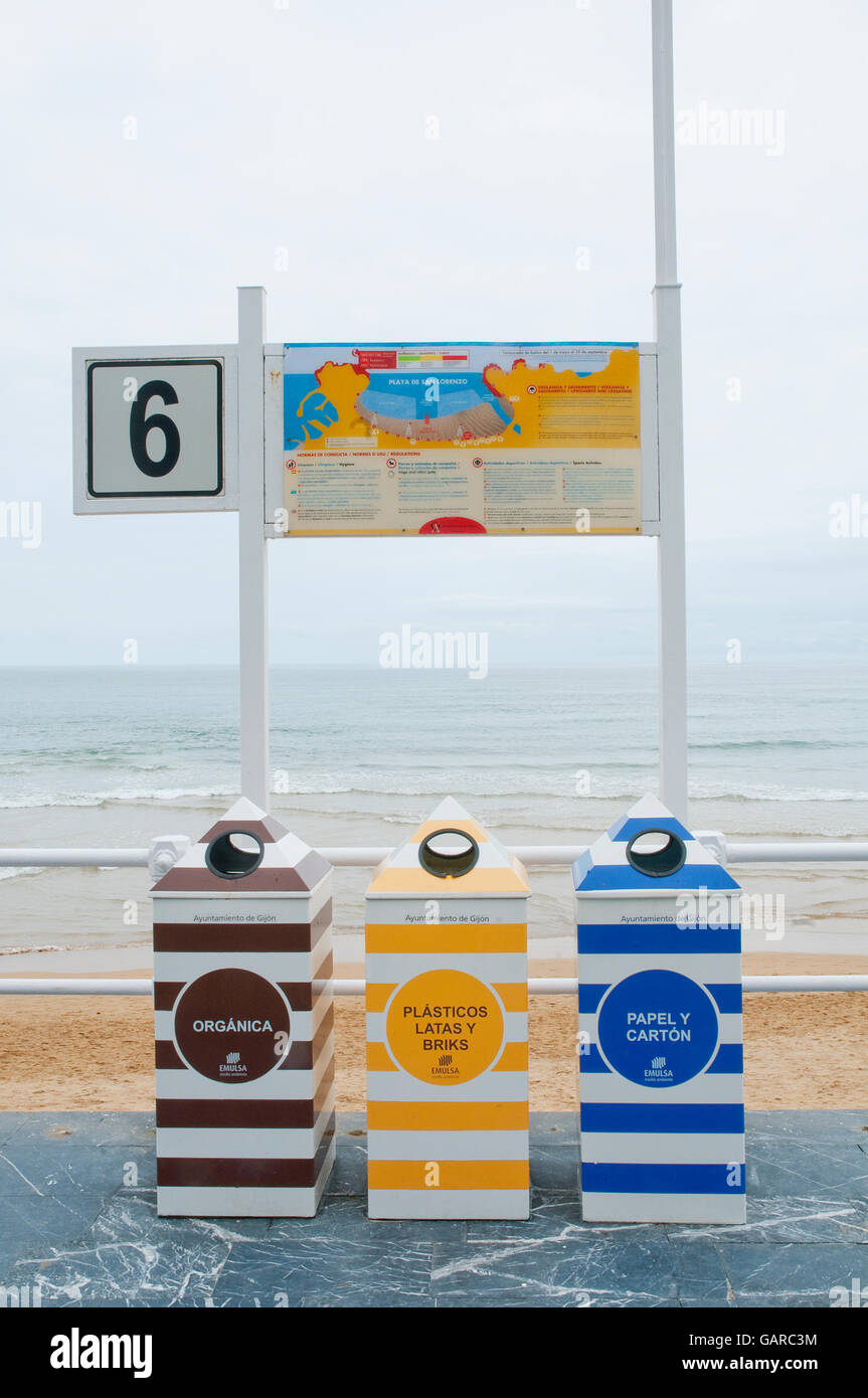 Three recycling bins in the promenade. San Lorenzo beach, Gijon, Asturias, Spain. Stock Photo