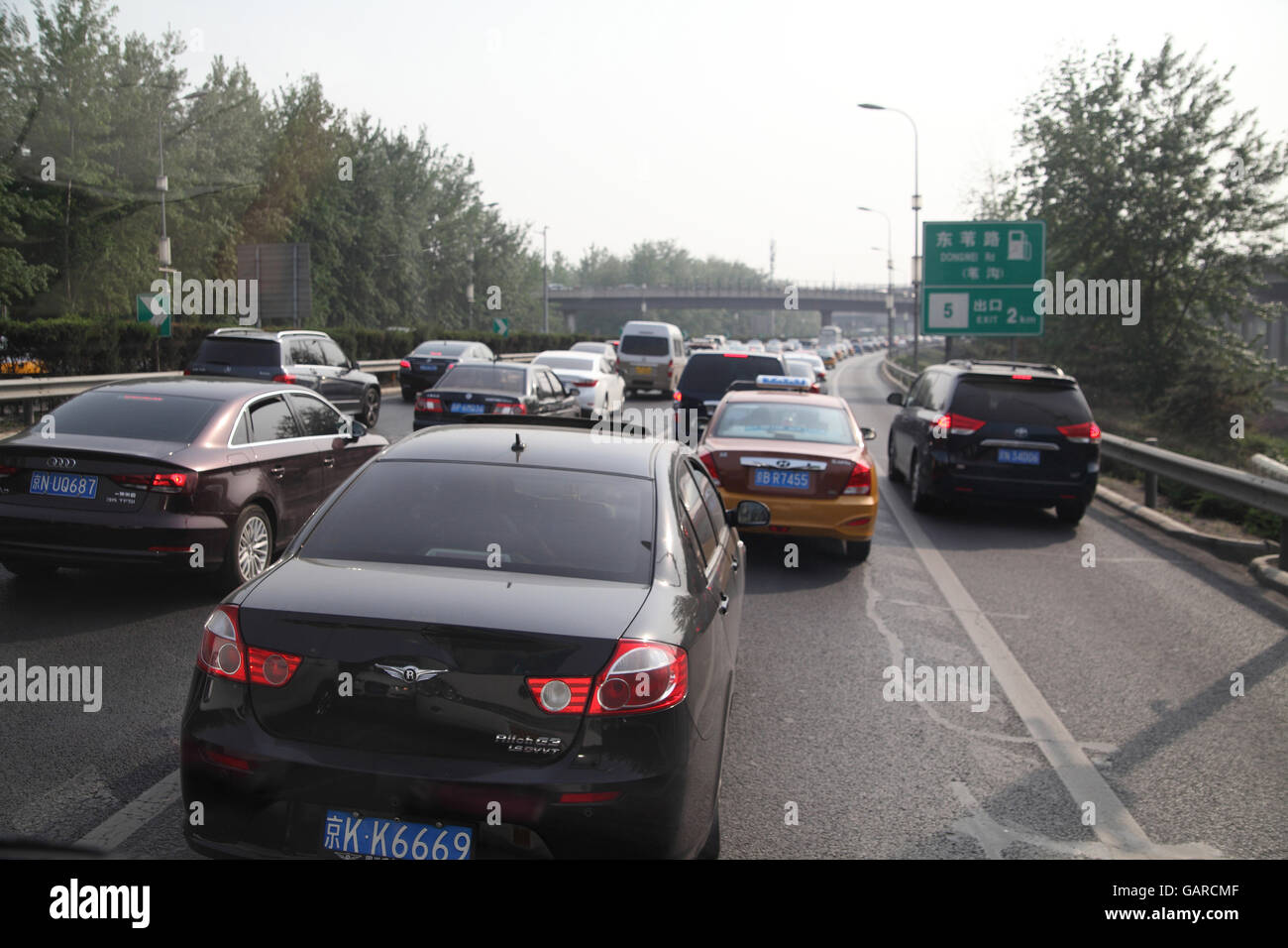 Heavy traffic of modern cars, a big city traffic jam on the Expressway 12 or the Airport Expressway going from the airport to Beijing. China. Stock Photo