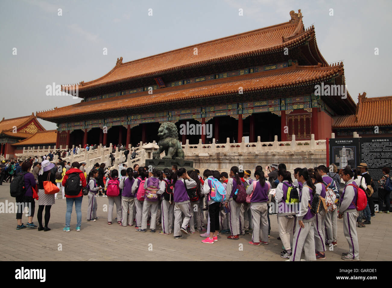 Chinese students on an outing with their teachers in the Forbidden City, they wait quietly before the Gate of Supreme Harmony. Stock Photo