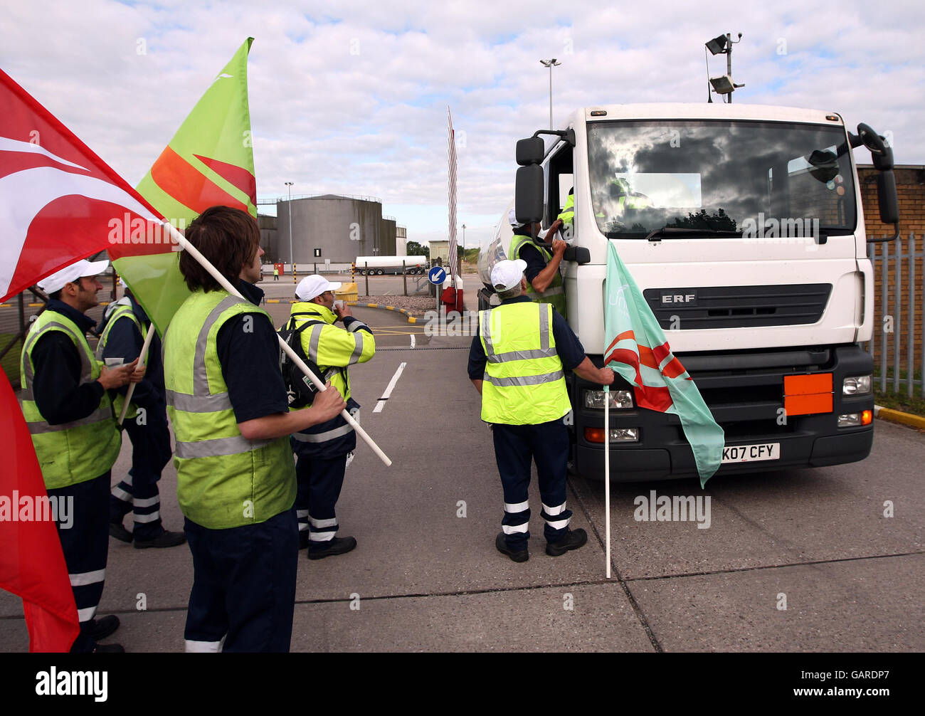 Picketers talk to tanker drivers as they leave the Kingsbury fuel depot