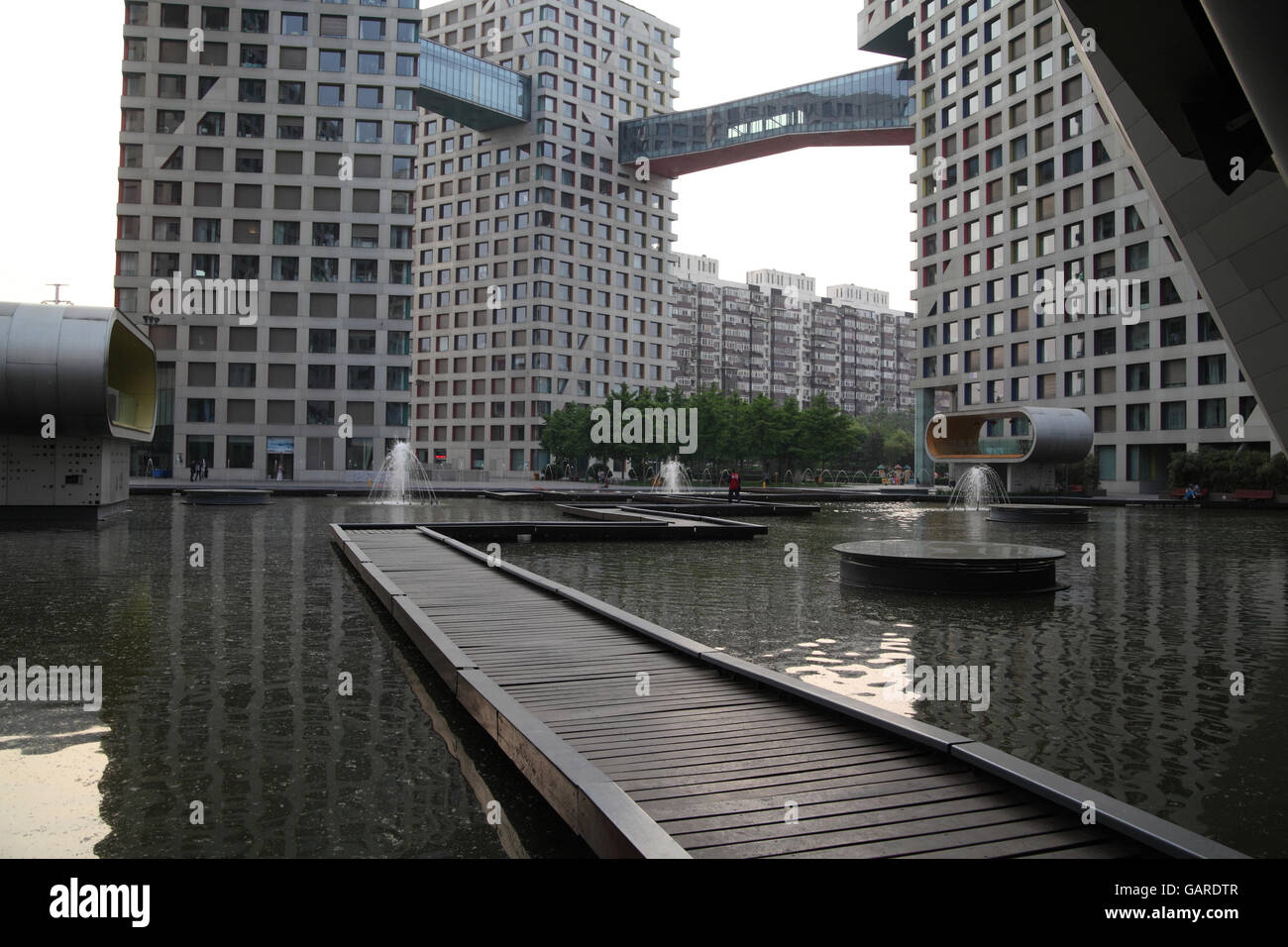 The Moma exclusive residential project designed by famed architect Steven Holl with a lake and covered bridges connecting the houses. Beijing, China. Stock Photo