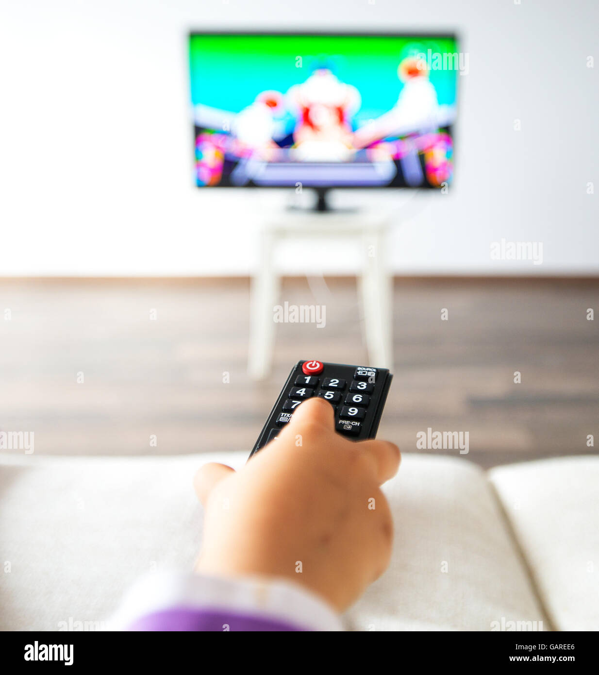 Little kid watching TV in the living room Stock Photo