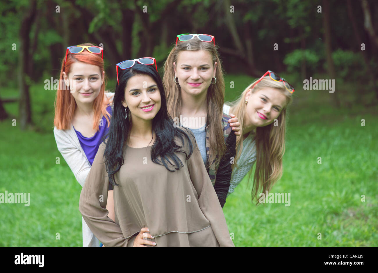 Happy friends posing together on a summer day Stock Photo - Alamy