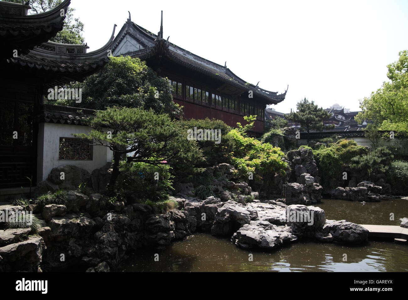 A house, a pond and vegetation in the Yu Garden or Yuyuan Garden, a typical 16th century Chinese classical garden. Shanghai, China. Stock Photo