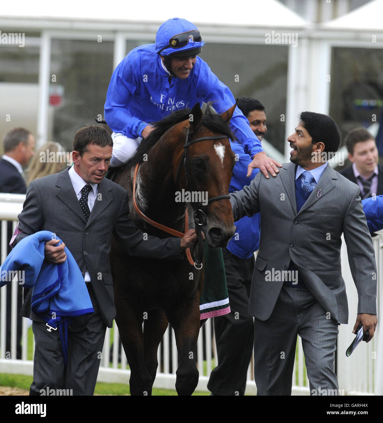Trainer Saeed bin Suroor (right) is congratulated by jockey Frankie Dettori after victory on Creachadoir in The Juddmonte Locking Stakes during the Juddmonte Lockinge Day at Newbury Racecourse. Stock Photo