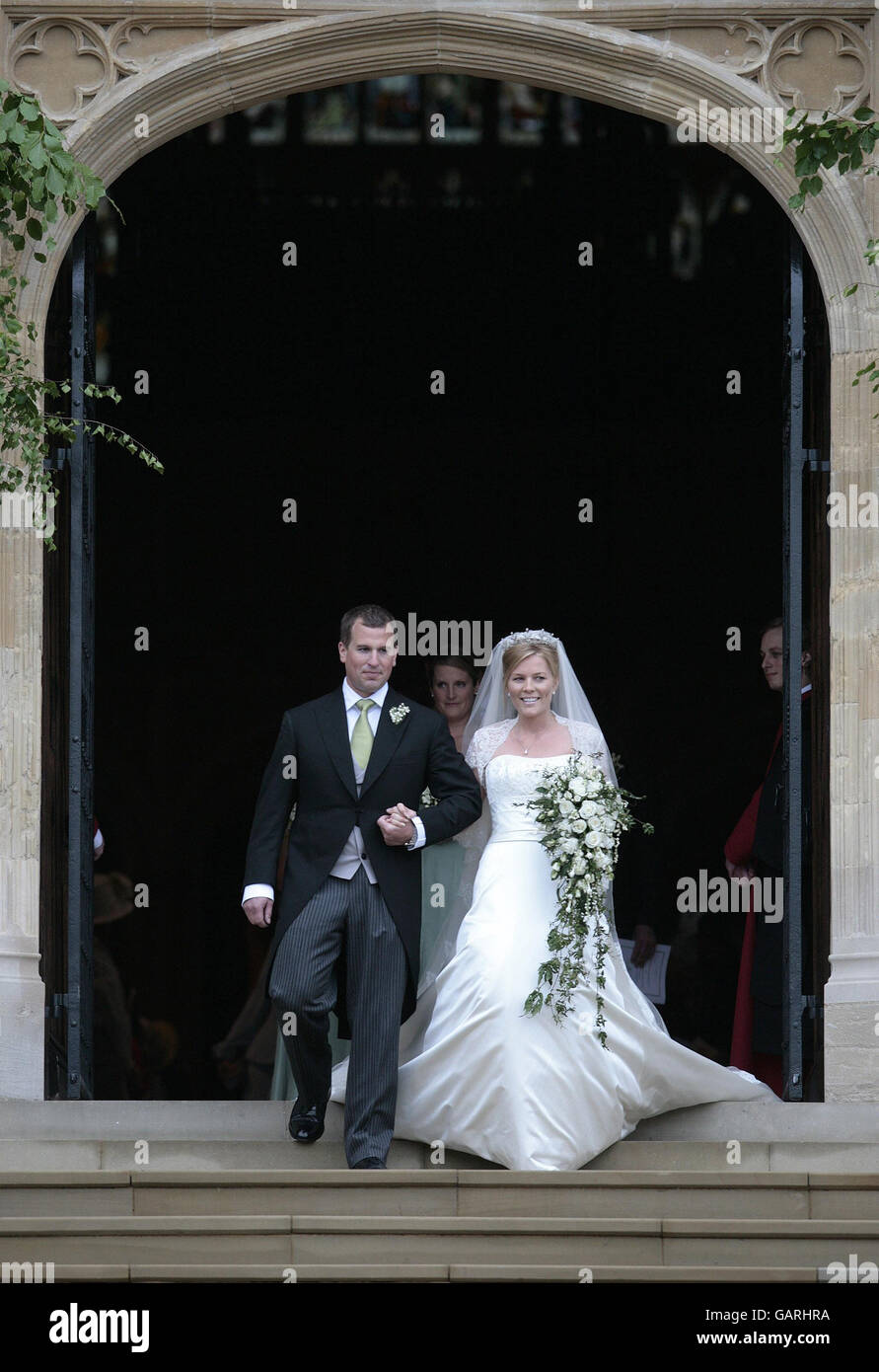 Peter Phillips, the eldest grandson of Queen Elizabeth II and Canadian Autumn Kelly leave St. George's Chapel in Windsor, England, after their marriage ceremony. . Stock Photo