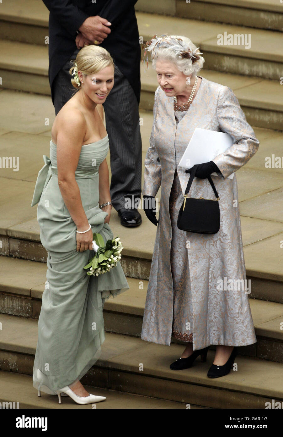 Queen Elizabeth II, talks to her grand-daughter Zara Phillips the marriage ceremony of Peter Phillips and Autumn Kelly. Stock Photo