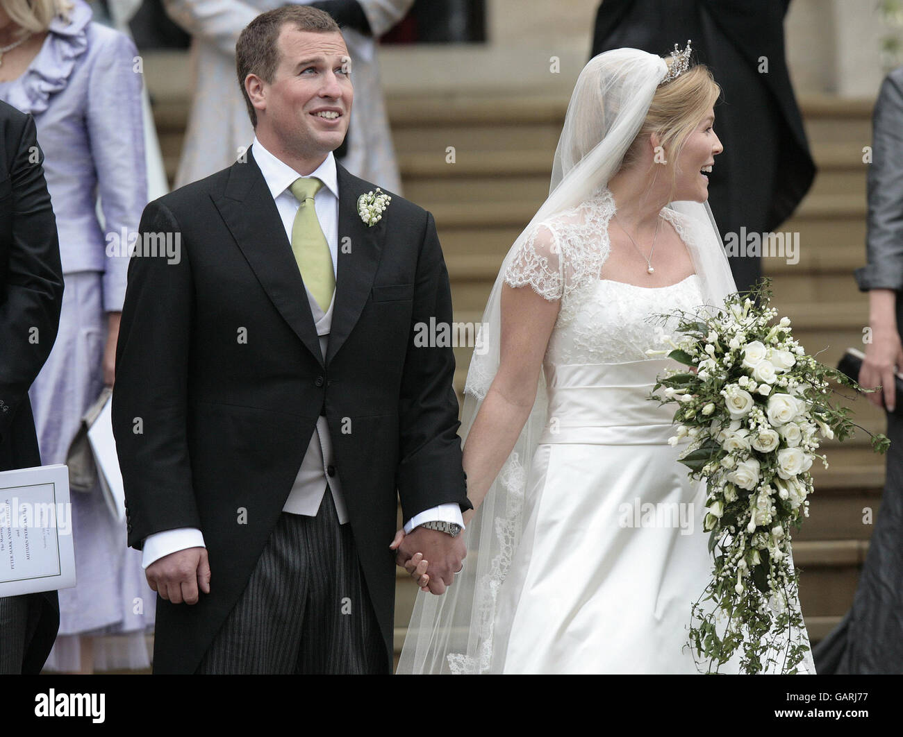 Peter Phillips, the eldest grandson of Queen Elizabeth II and Canadian Autumn Kelly leave St. George's Chapel in Windsor, England, after their marriage ceremony. . Stock Photo