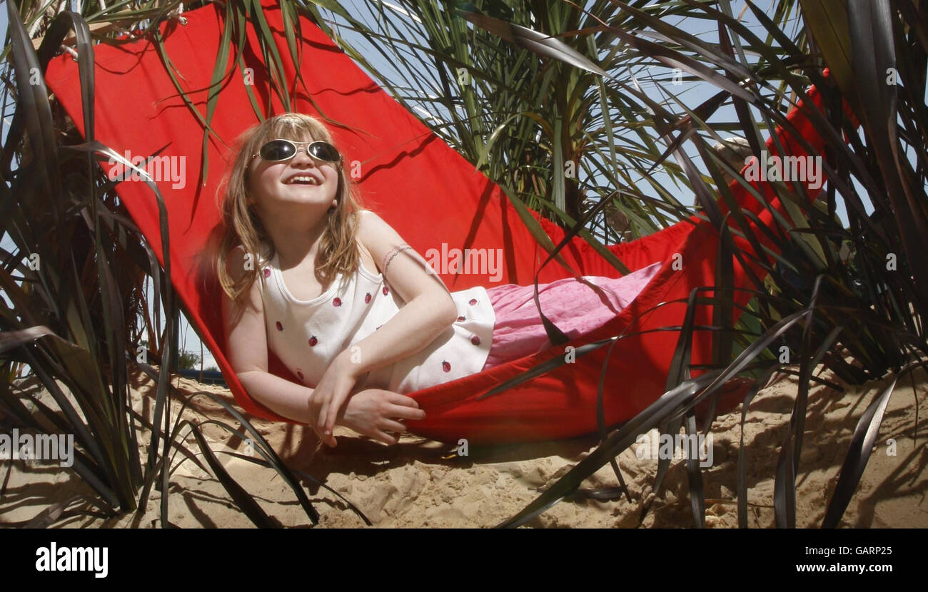 Seven-year-old Kim Hunter relaxes in the sun during a visit to Gardening Scotland 2008 at the Royal Highland Centre near Edinburgh. Stock Photo