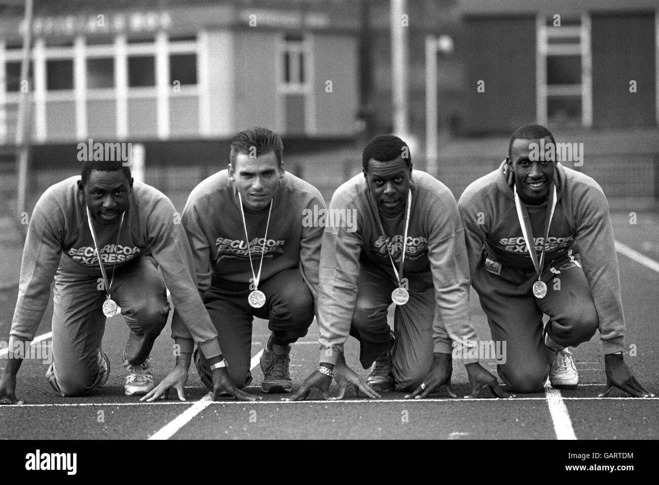 Great Britain's Olympic relay squad at the West London Stadium, showing off their silver medals they won in the 4x100 metres sprint relay in Seoul. From left, Clarence Callender (reserve), Elliot Bunney, Mike McFarlane and Linford Christie. Stock Photo