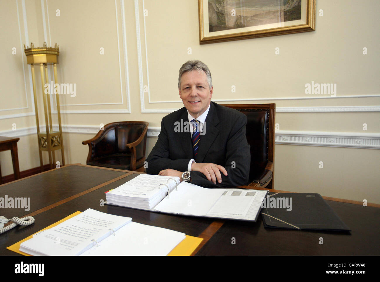 Northern Ireland's new First Minister Peter Robinson behind his desk after being nominated as First Minister in the Parliament Buildings, Stormont, Northern Ireland. Stock Photo