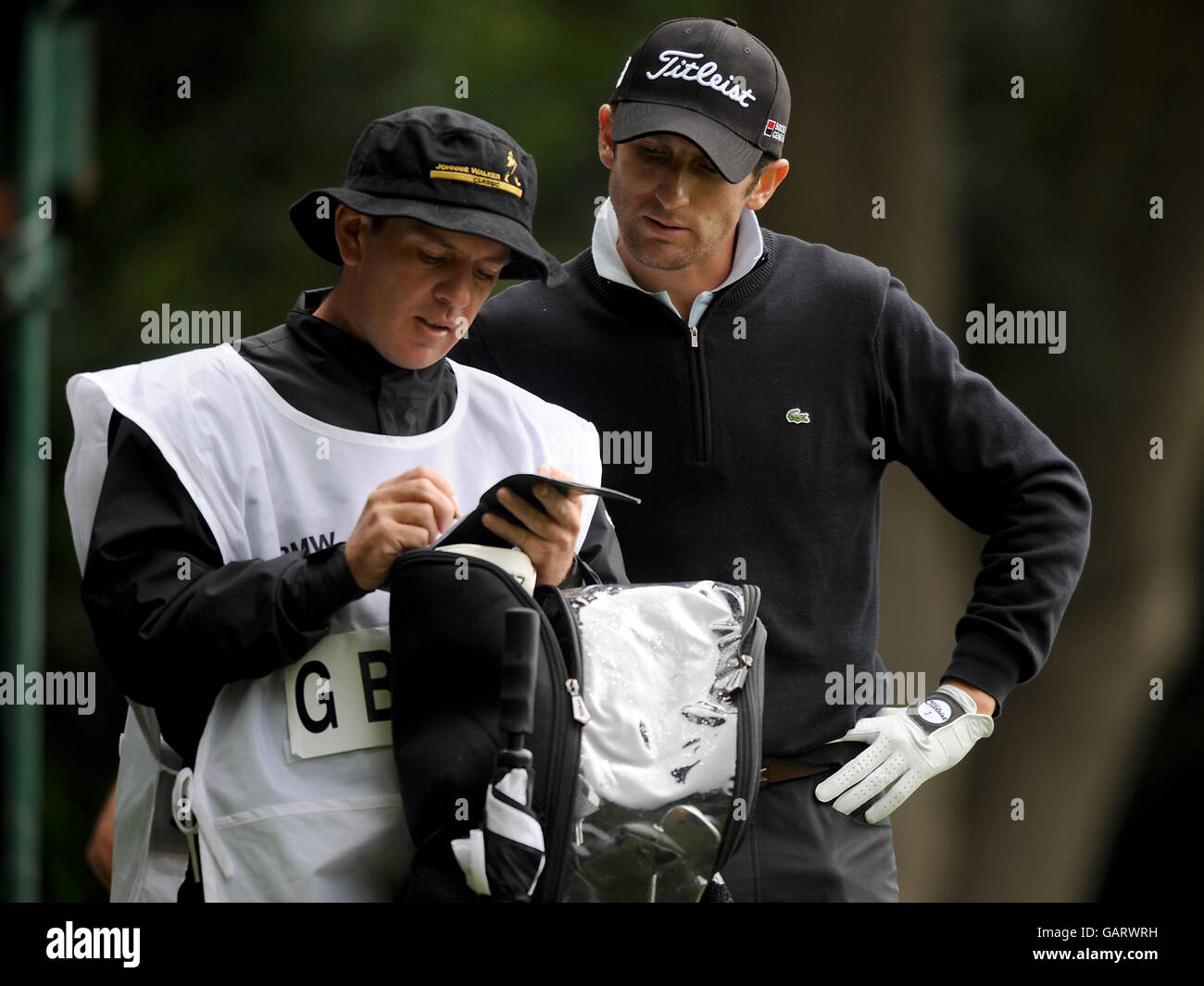 Golf - BMW PGA Championship 2008 - Round Four - Wentworth Golf Club - Virginia Water. Gregory Bourdy (r) checks his opponent's card with his caddie during the BMW PGA Championship at Wentworth Stock Photo