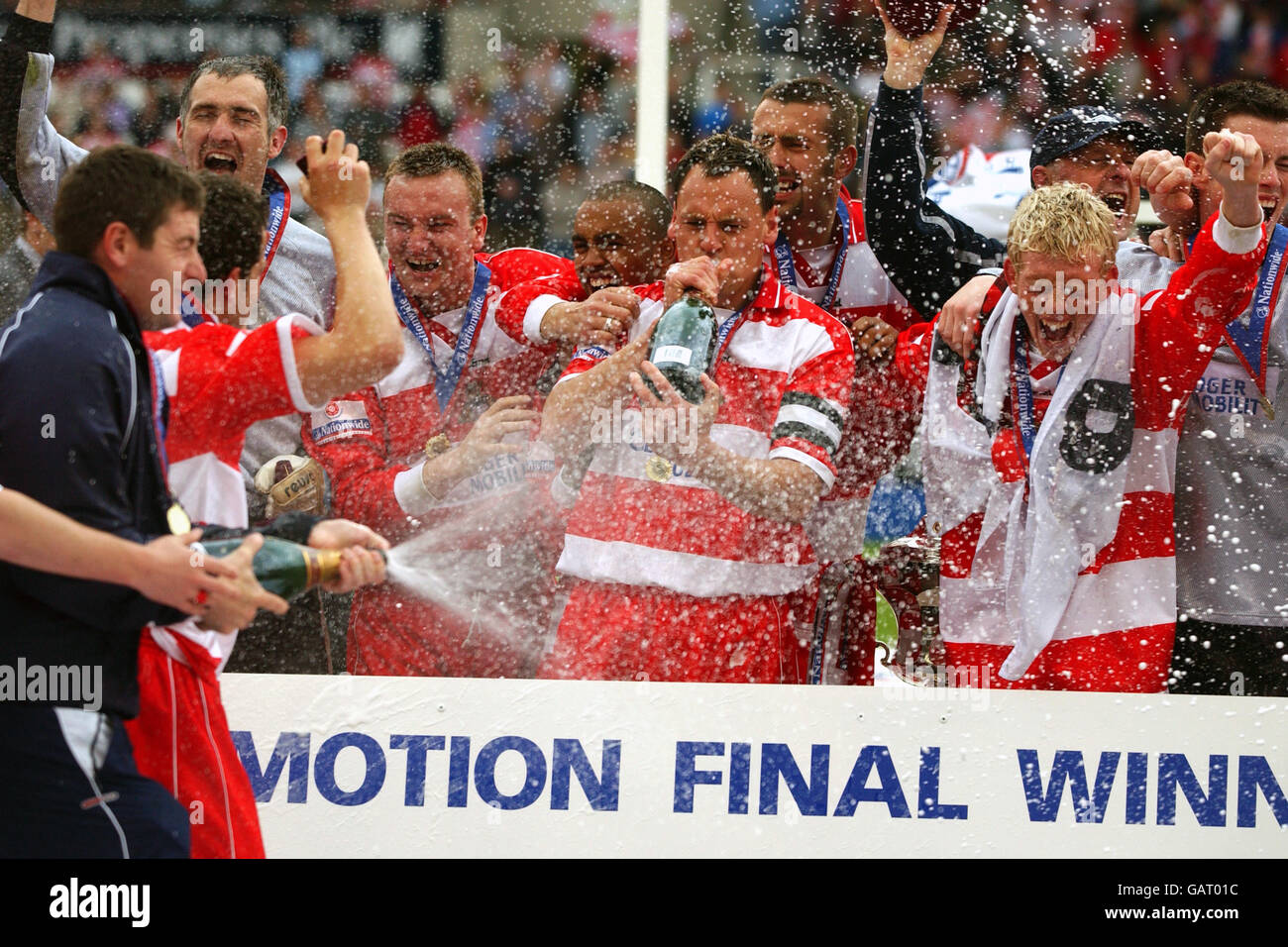 Doncaster Rovers players celebrate a return to the Football League after 5 seasons in the Conference by spraying champagne Stock Photo