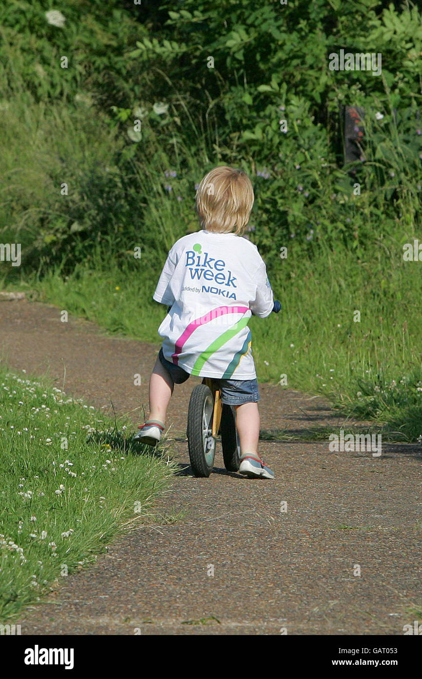 Three-year-old Arthur Birkbeck from Clapton, enjoys a bike ride in Hackney, north London, for the launch of Bike Week. Stock Photo