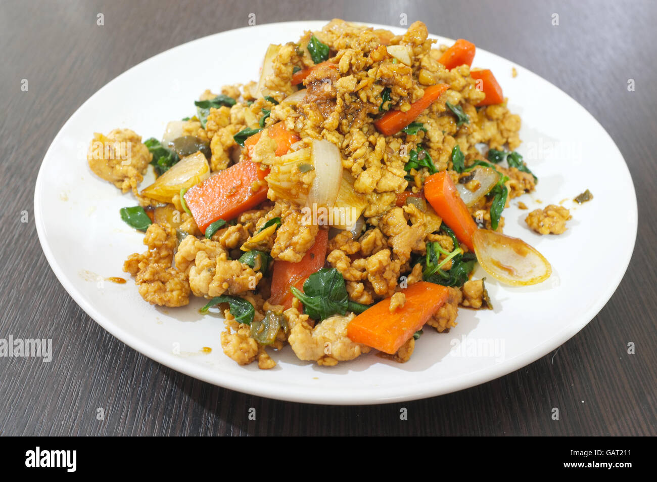 Stir fry basil leaves with chicken, carrot and onion, Thai food Stock