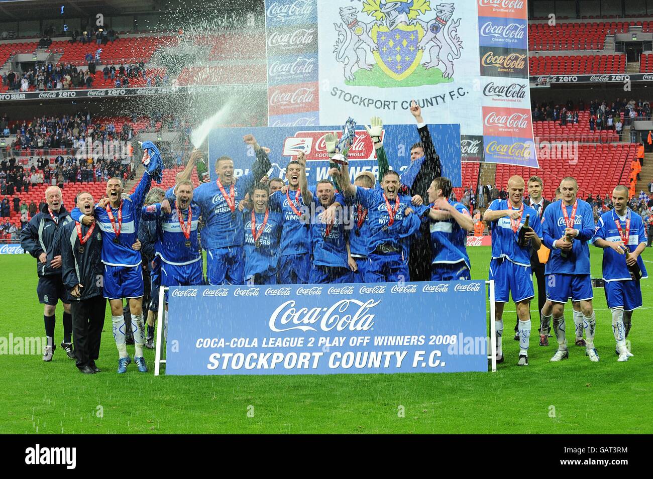 Stockport County players celebrate with the trophy after the final