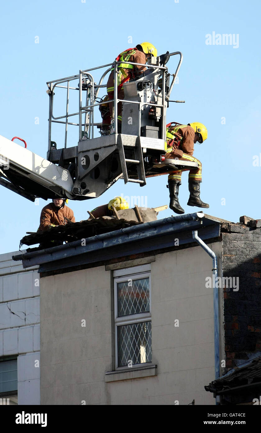 West Midlands Fire service personnel at the scene after the roof of building in West Bromwich High Street collapsed. Stock Photo