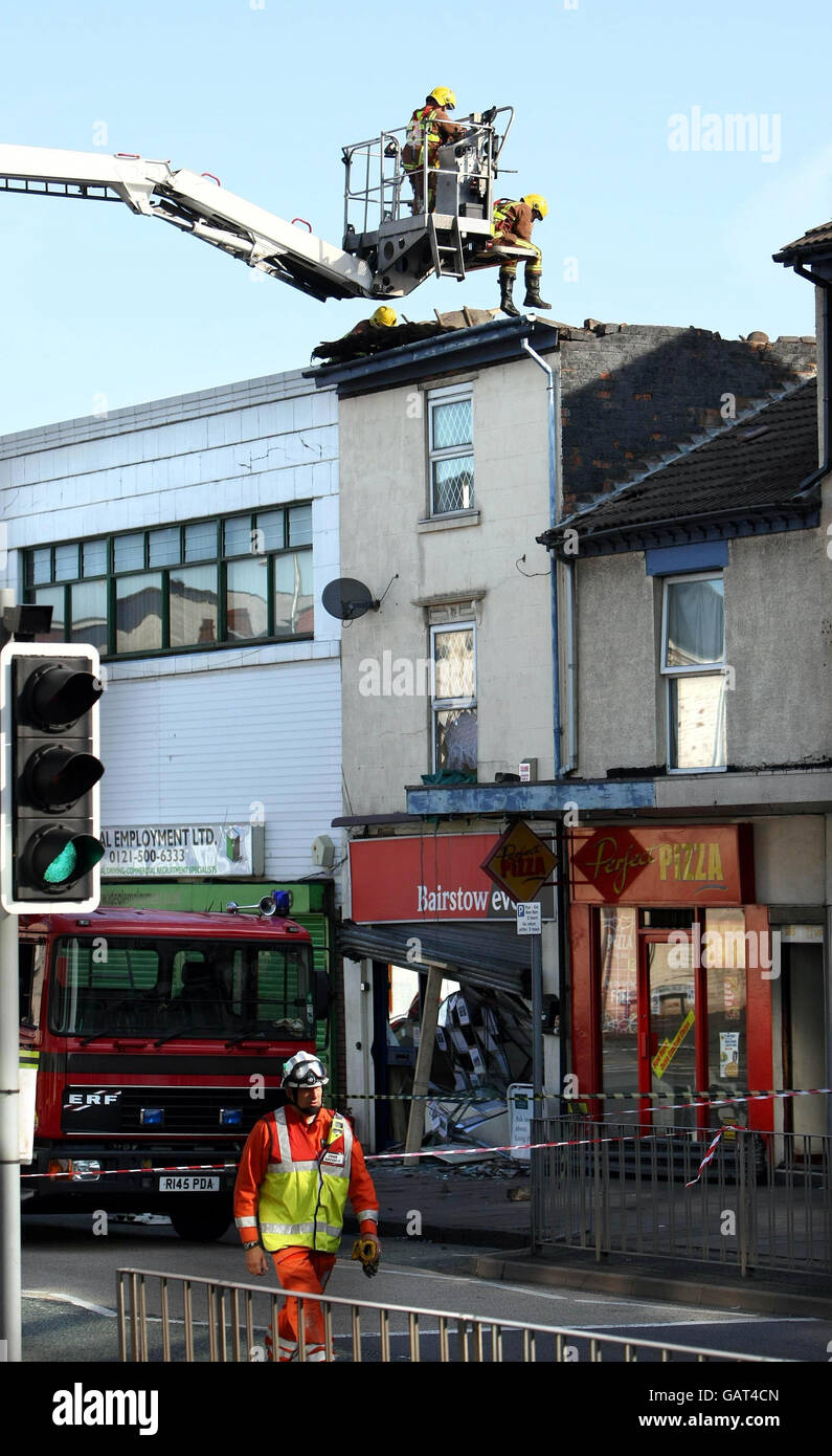 West Midlands Fire service personnel at the scene after the roof of building in West Bromwich High Street collapsed. Stock Photo