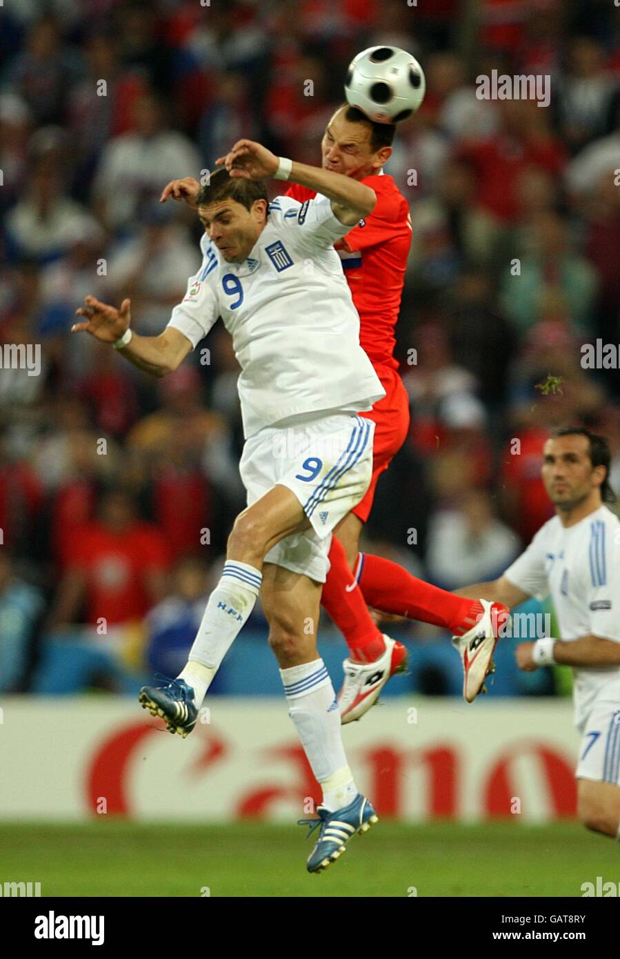 Soccer - UEFA European Championship 2008 - Group D - Greece v Russia - Wals Siezenheim Stadium. Greece's Angelos Charisteas (left) and Russia's Sergei Ignashevich battle for the ball in the air. Stock Photo