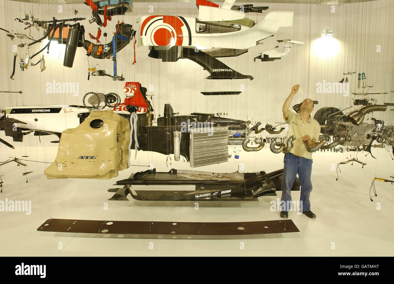 Paul Veroude puts the finishing touches to his work, 'View Suspended', an exploded view of a Honda Racing Formula 1 car, at the British International Motor Show at Excel, east London. Stock Photo