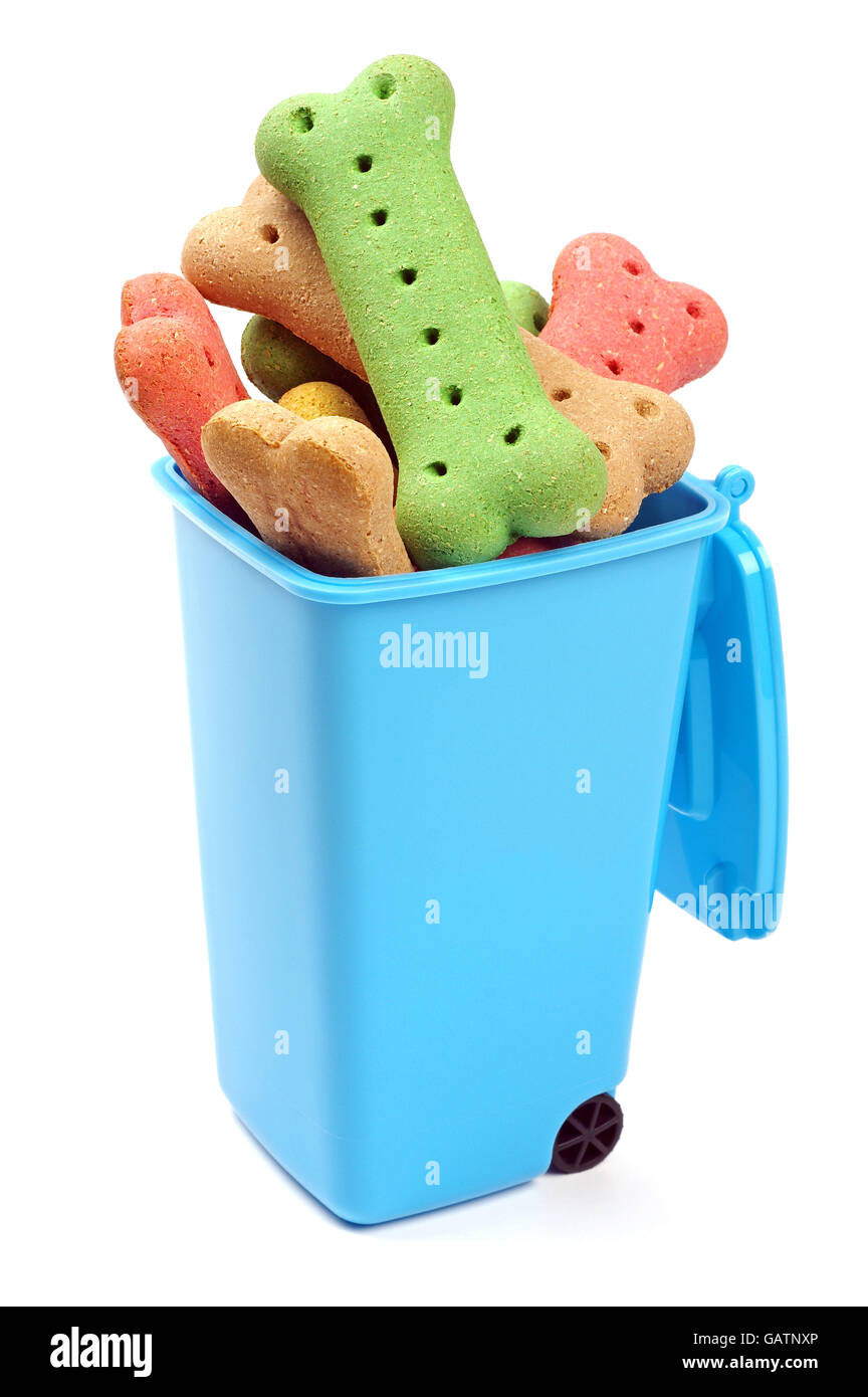 coloured dog bones in a blue rubbish bin Stock Photo