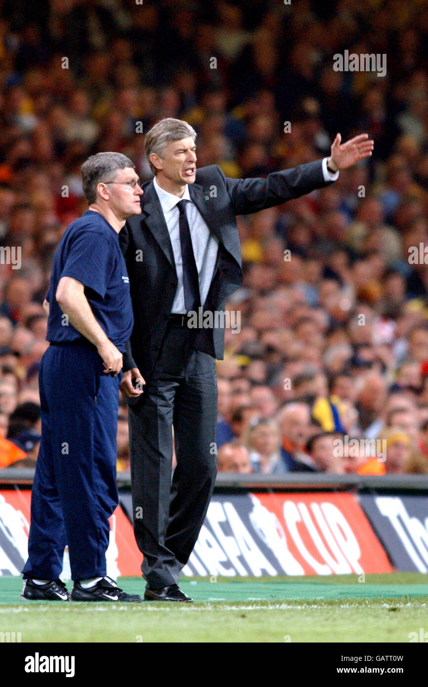 Arsenal's manager Arsene Wenger with his assistant Pat Rice direct the their team against Southampton Stock Photo