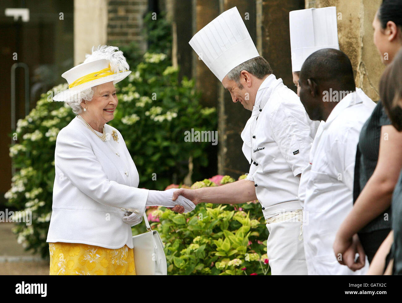Britain's Queen Elizabeth II meets members of staff at Sutton's