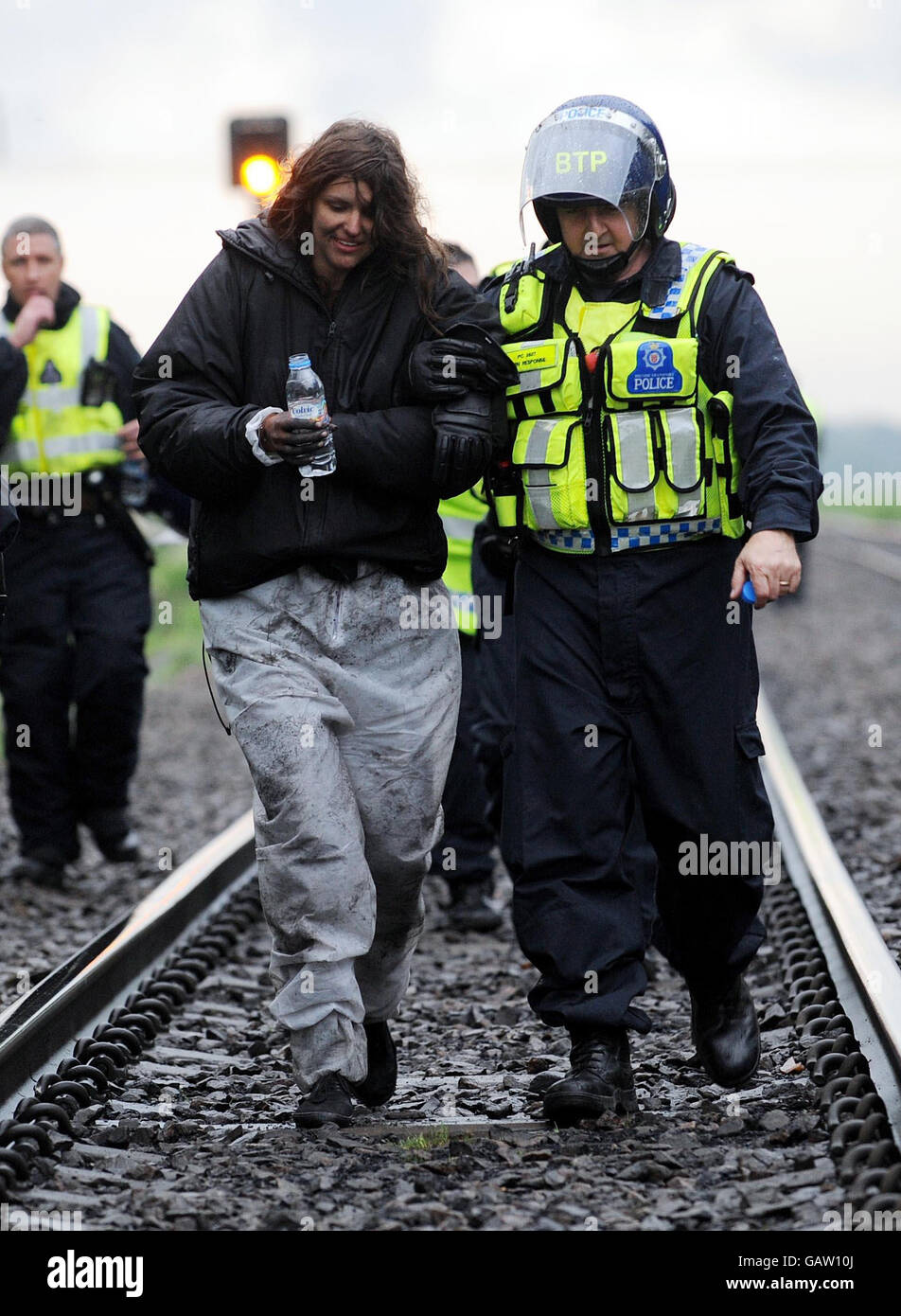 Police lead away climate protesters after they boarded a coal train a few miles south of Drax power station in North Yorkshire. Stock Photo