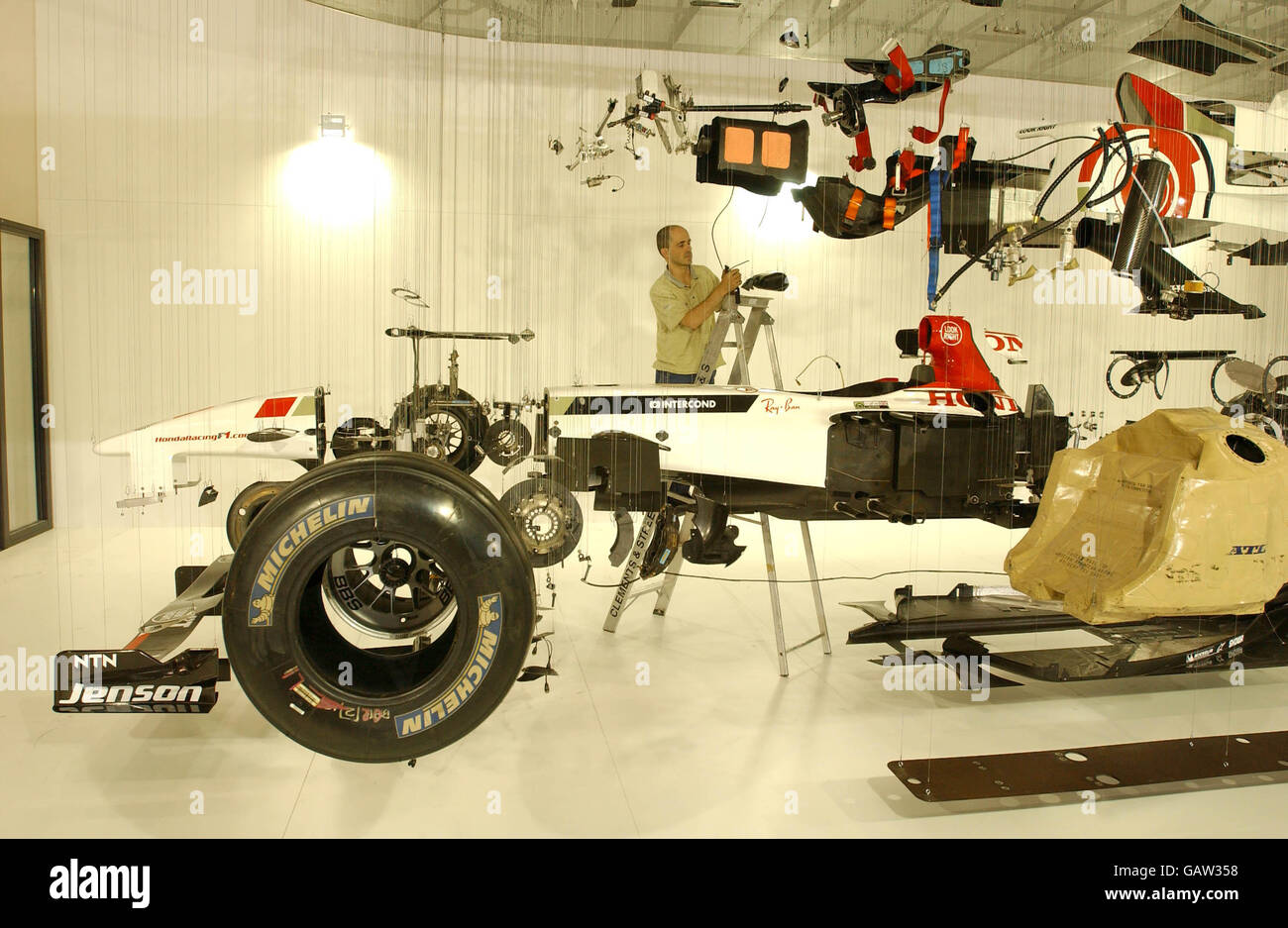Paul Veroude puts the finishing touches to his work, 'View Suspended', an exploded view of a Honda Racing Formula 1 car, at the British International Motor Show at Excel, east London. Stock Photo