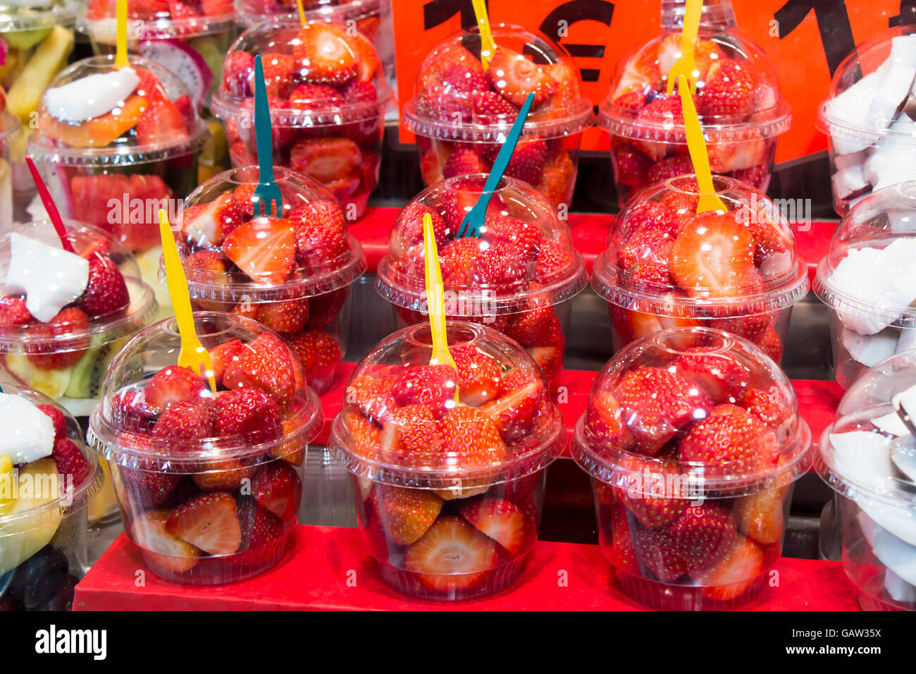 Fresh Strawberry cocktail salad in plastic cups on a market stall Stock Photo