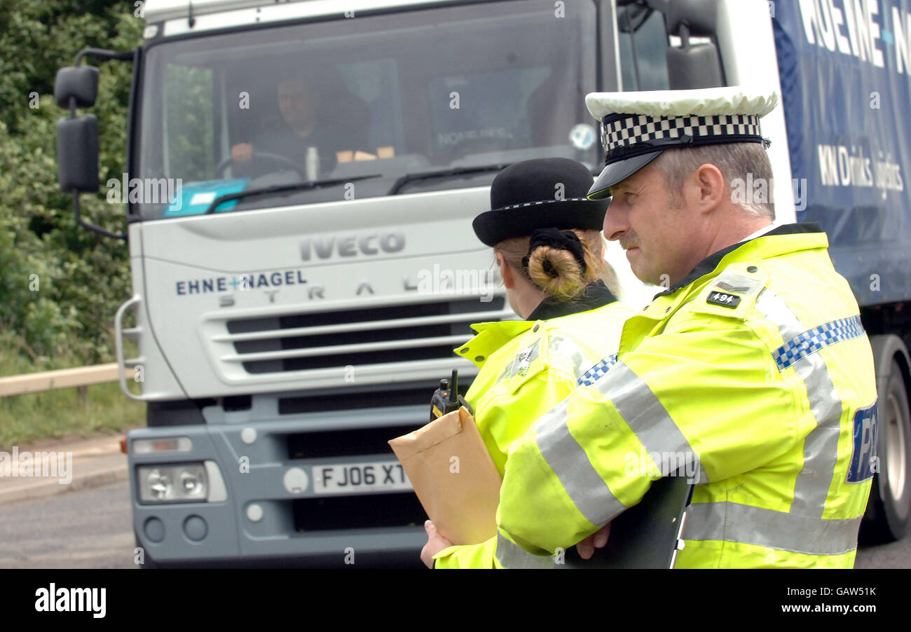 Police officers watch, as truckers gather for a demonstration along the M62 in West Yorkshire to protest against high fuel prices. Stock Photo